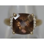 9ct gold dress ring set with a brown stone and diamonds. Ring size P. Approx weight 3.1 grams. (B.P.