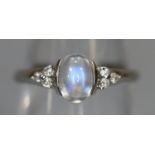 9ct white gold ring set with a moonstone and diamonds. Ring size O & 1/2. Approx weight 2.2