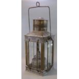 Early 20th Century copper and glass lantern with swing handle, the interior revealing a single oil