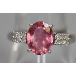 9ct white gold ring set with an oval pink stone and diamonds. Ring size O. Approx weight 2.8