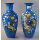 Pair of Japanese Noritake porcelain blue ground vases, overall decorated with exotic birds amongst