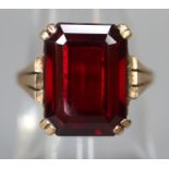 9ct gold dress ring set with a step cut red stone. Ring size M & 1/2. Approx weight 4.7 grams. (B.P.