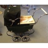 Vintage dolls pram, appearing unmarked, with mid century plastic doll. (B.P. 21% + VAT)