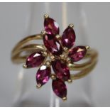 9ct gold flower shaped ring set with pink stones. Ring size O. Approx weight 3.1 grams. (B.P.