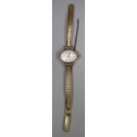 Everite 9ct gold ladies oval wristwatch with Baton and Roman numerals on a plated strap. (B.P. 21% +