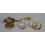A gold plated locket and three costume rings. (B.P. 21% + VAT)