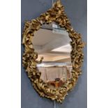 Modern gilt framed cherub mounded oval mirror. 70x47cm approx. (B.P. 21% + VAT)