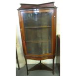 Edwardian mahogany inlaid serpentine single door glazed corner display cabinet with under tier on