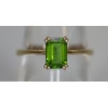 9ct gold dress ring set with a step cut green stone. (B.P. 21% + VAT)