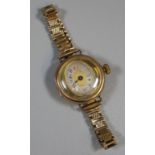 9ct gold ladies wristwatch with unusual oval dial on 9ct gold bracelet. 20g in total approx. (B.P.