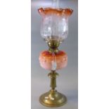 Early 20th Century double oil burner lamp, having clear frosted and orange foliate shade, above an