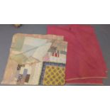 Two vintage cotton quilts: one a dark pink Welsh quilt with swirling details and central roundal and
