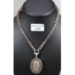 Victorian white metal oval shaped engraved locket and chain. (B.P. 21% + VAT)