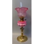 Early 20th Century double oil burner lamp base, having frosted etched foliate cranberry shade,