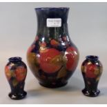 Moorcroft art pottery tube lined pomegranate design baluster vase. 22cm high approx. Together with a