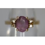9ct gold purpe stone ring set with diamonds. Ring size M & 1/2. Approx weight 3.2 grams. (B.P. 21% +