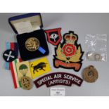 Plastic box of GB silver coins and military items, to include: boxed medallions, uniform patches,