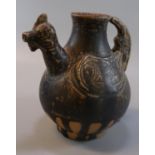 An archaic zoomorphic pottery baluster jug with cockerel's head spout, applied wing designs and