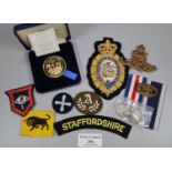 Small collection of GB silver coins and militaria items, medallions, uniform patches, cap badges,