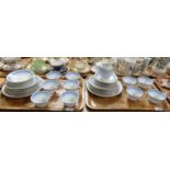 Two trays of continental blue, white and gilt teaware including: teacups, saucers, plates, milk