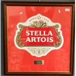 A framed 'Stella Artois' presentation advertising panel, bearing plaque 'For achieving in excess