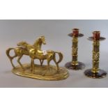 Pair of enamelled brass candle sticks with wrythen and geometrically decorated columns. 15cm high