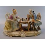 Capodimonte porcelain figural group of a couple at a table playing chess. (B.P. 21% + VAT)