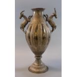 Unusual middle eastern design white metal vase of baluster form, the handles decorated with stylised