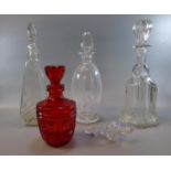 Collection of glass decanters with stoppers, one of mallet form. (B.P. 21% + VAT)