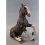 Raku pottery model of a seated horse by 'K Rudge', signed. 31cm high approx. (B.P. 21% + VAT)