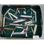 Tin box of assorted fruit and penknives, mother of pearl, Swiss Army type knives etc. some