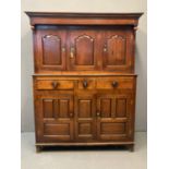 Early 19th Century Welsh oak Deuddarn, the moulded cornice flanked by carved baluster finials