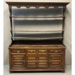 19th Century oak two stage open back dresser, the moulded cornice above carved frieze with fitted
