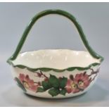 19th Century Llanelly pottery Shufflebotham wild rose fruit basket with high loop handle. 21cm