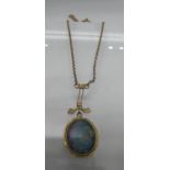 An Edwardian opal pendant set in yellow metal on a yellow metal chain. Approx weight 4.1 grams. (B.