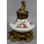 Continental porcelain and ormolu single desk inkwell, the lid with cherub finial above a porcelain