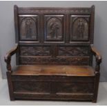 18th century oak arch backed settle with box seat and scrolled open arms, overall with 19th
