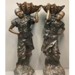 Pair of life sized patinated hollow cast bronze Blackamoor figures, men carrying large clam