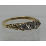 An 18ct gold three stone diamond ring. Ring size N. Approx weight 2.4 grams. (B.P. 21% + VAT)