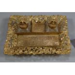 French gilt metal desk inkwell set, the base with chased floral and foliate decoration, three