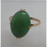 A jade ring set in unmarked yellow metal. Ring size Q. Approx weight 2.4 grams