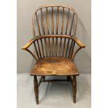 19th Century elm and ash Windsor armchair, having solid moulded seat on ring turned legs. (B.P.