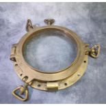 Large heavy brass ship's porthole with frame and locking screws. Overall 43cm diameter approx. (B.P.