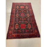 Rich navy and red ground Kurdish rug with unique medallion designs. 228x122cm approx. (B.P. 21% +