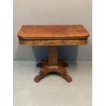 19th century mahogany tea table standing on a shaped pedestal and four scroll and paw feet.