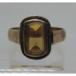 A yellow stone ring on a 22ct gold band. Ring size V&1/2. Approx weight 6 grams. (B.P. 21% + VAT)