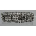 Diamond openwork bracelet of hinged square links with hinged integral clasp. Set in unmarked white