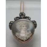 19th century painted portrait pendant depicting a lady in 18th century dress, the frame decorated