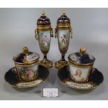 Pair of early 20th Century Sevres porcelain hot chocolate cups, covers and saucers, on a cobalt blue