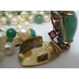 A Seaman Schepps emerald and pearl four row choker with 14ct gold ornate clasp set with emeralds,